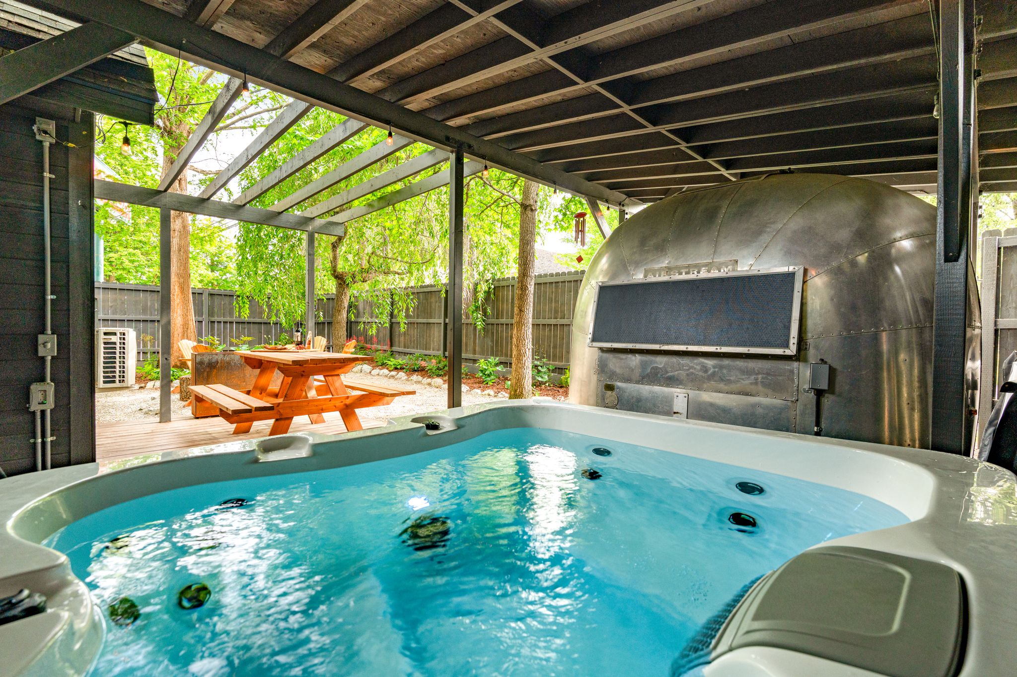 Private hot tub next to vintage Airstream sauna