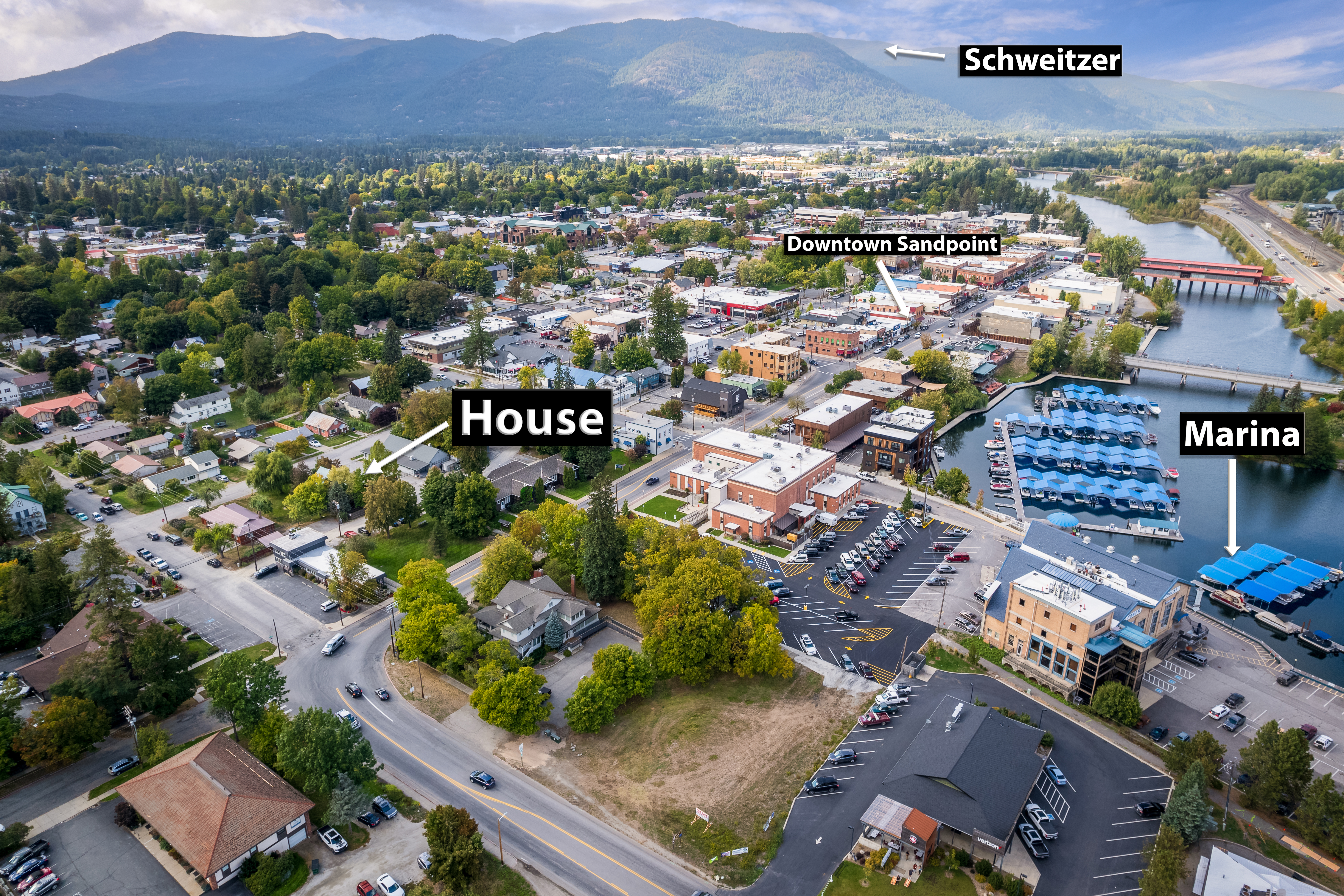 Aerial view showing property location near downtown Sandpoint, marina, and Schweitzer Mountain